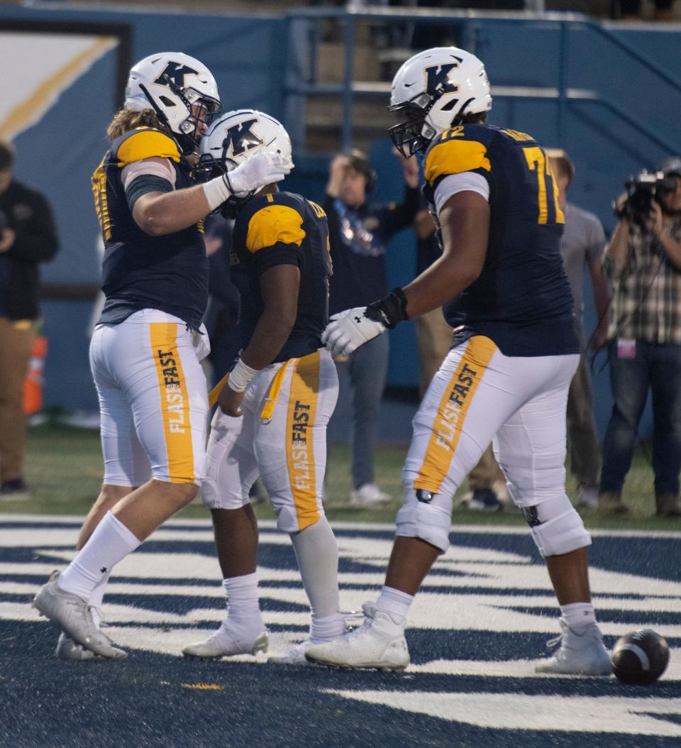 Hayden Junker and Marcellus Marshall go to Marquez Cooper after he scored a touchdown in overtime.