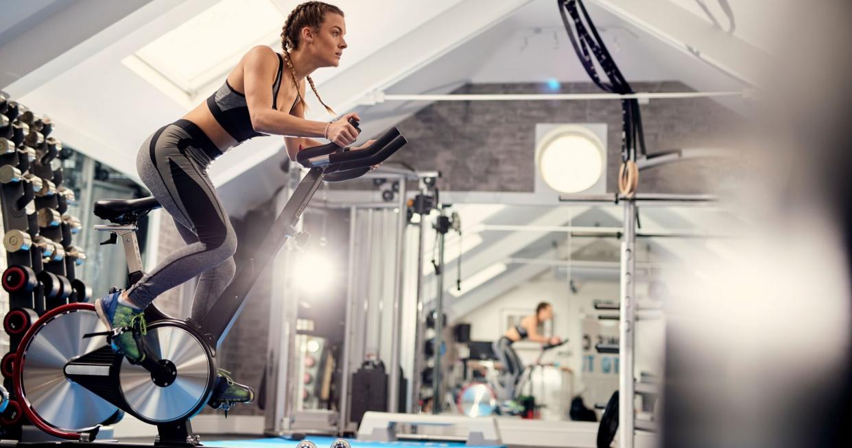 woman spinning in a private or at-home gym