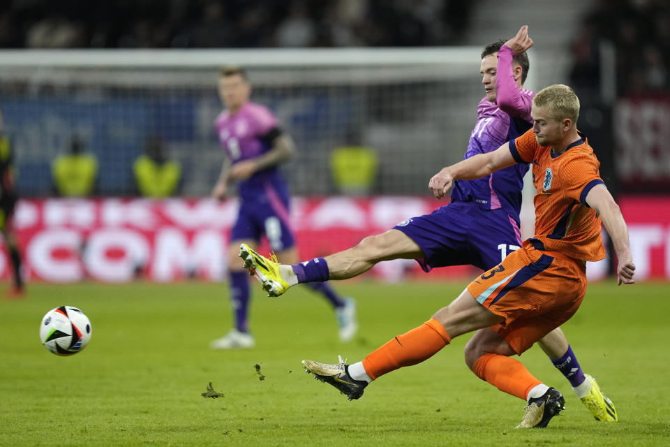 Germany's Florian Wirtz, left, tries to block Germany's David Raum during the international friendly soccer match between Germany and Netherlands at the Deutsche Bank Park in Frankfurt, Germany on Tuesday, March 26, 2024. (AP Photo/Martin Meissner)