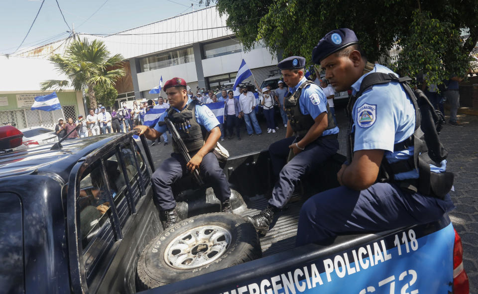 Police patrol near anti-government protesters wanting to march in Managua, Nicaragua, Wednesday, April 17, 2019. Police prevented the march to commemorate a year since Nicaraguan protesters took to the streets to oppose the government of President Daniel Ortega. (AP Photo/Alfredo Zuniga)
