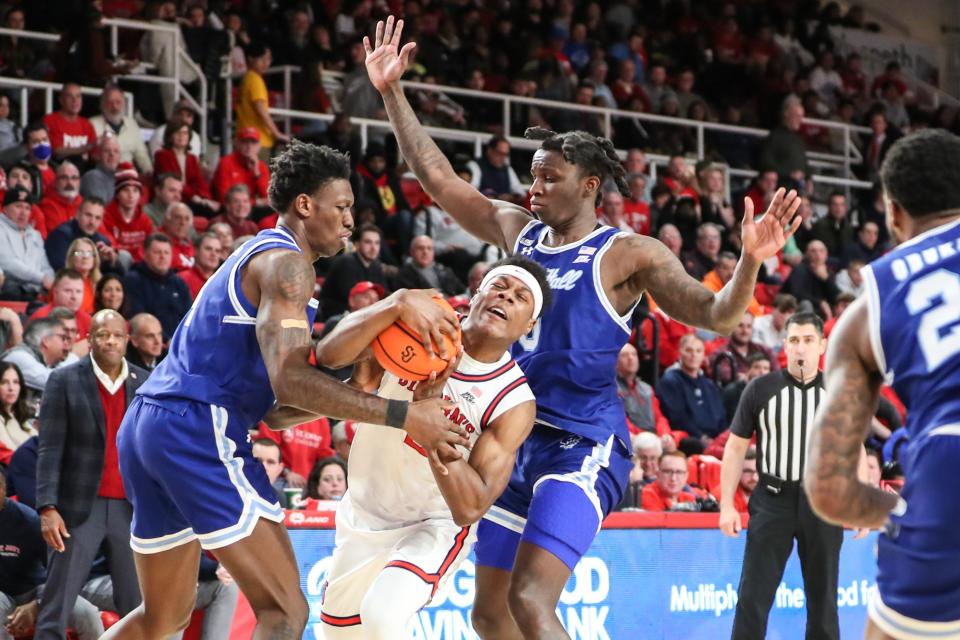 Feb 1, 2023; Queens, New York, USA;  St. John's Red Storm guard AJ Storr (2) is doubled teamed by Seton Hall Pirates forward Tyrese Samuel (4) and guard Kadary Richmond (0) in the second half at Carnesecca Arena.