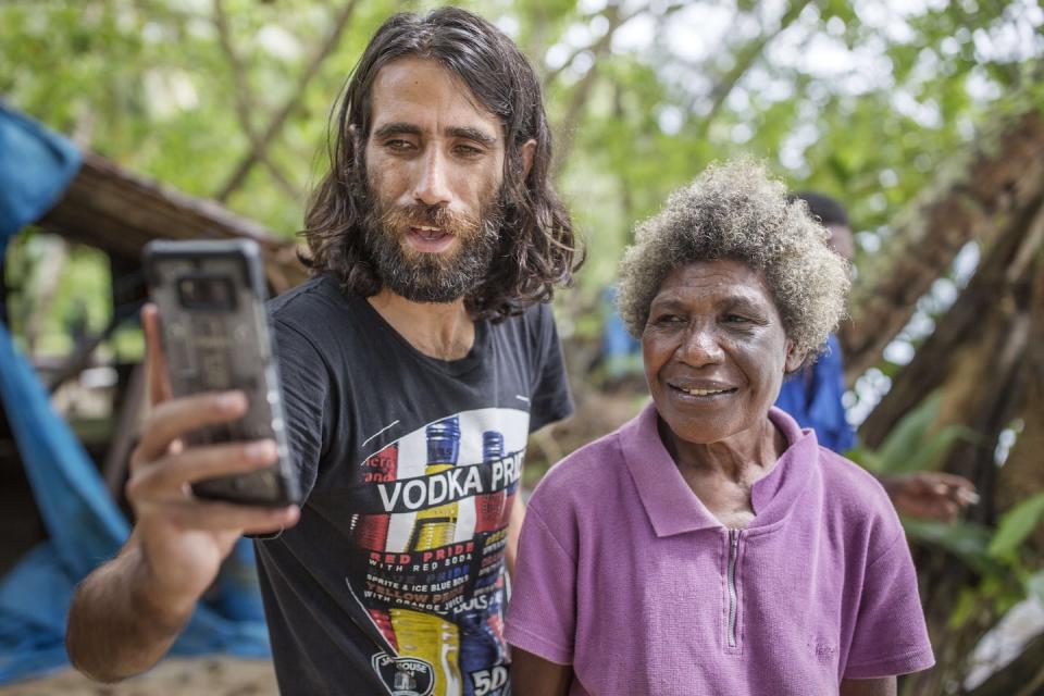 Boochani taking a selfie with local woman in Manus. Photo credit: Getty images. Author provided