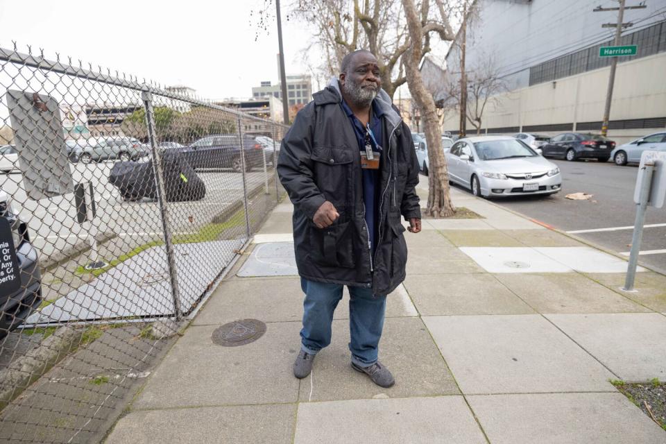 Lee Reed makes his way carefully along a sidewalk.