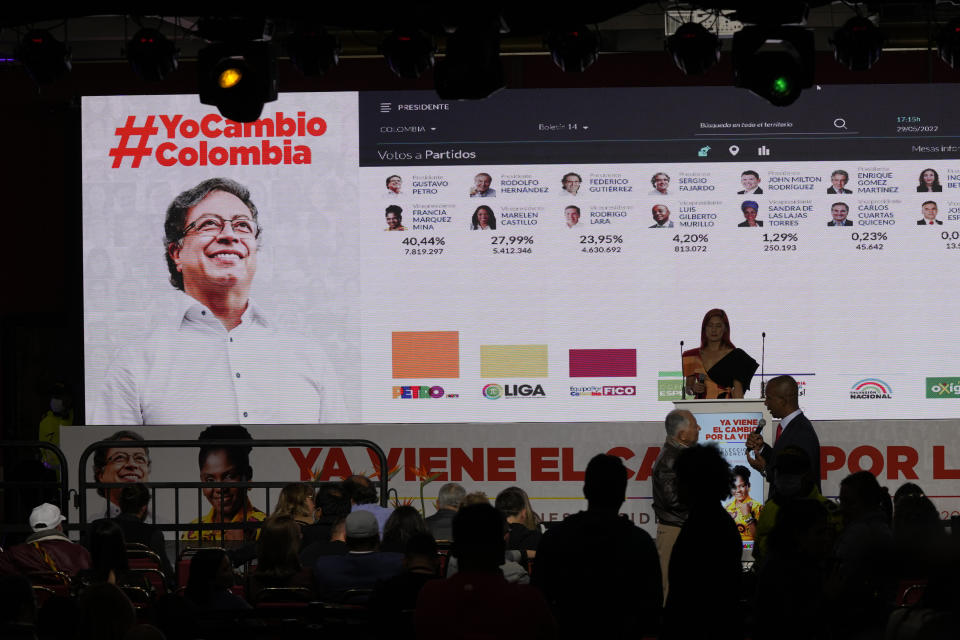 Partial results for presidential elections are shown on a screen where supporters of Gustavo Petro, presidential candidate with the Historical Pact coalition, gather after polls closed in Bogota, Colombia, Sunday, May 29, 2022. (AP Photo/Fernando Vergara)