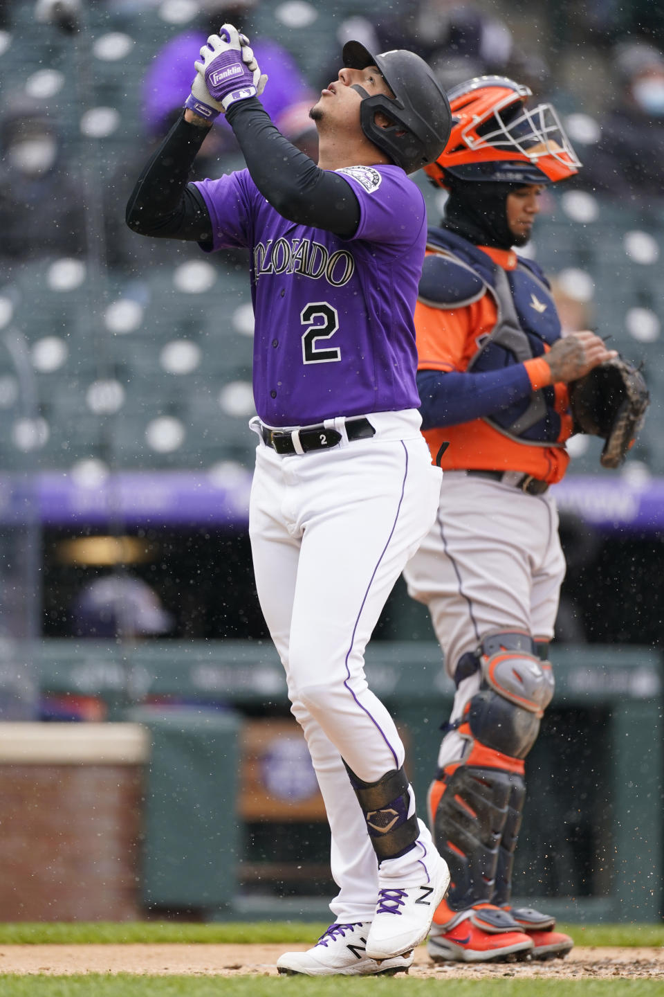 Colorado Rockies' Yonathan Daza, front, celebrates as he crosses home plate after hitting a solo home run as Houston Astros catcher Martin Maldonado looks on in the second inning of a baseball game Wednesday, April 21, 2021, in Denver. (AP Photo/David Zalubowski)