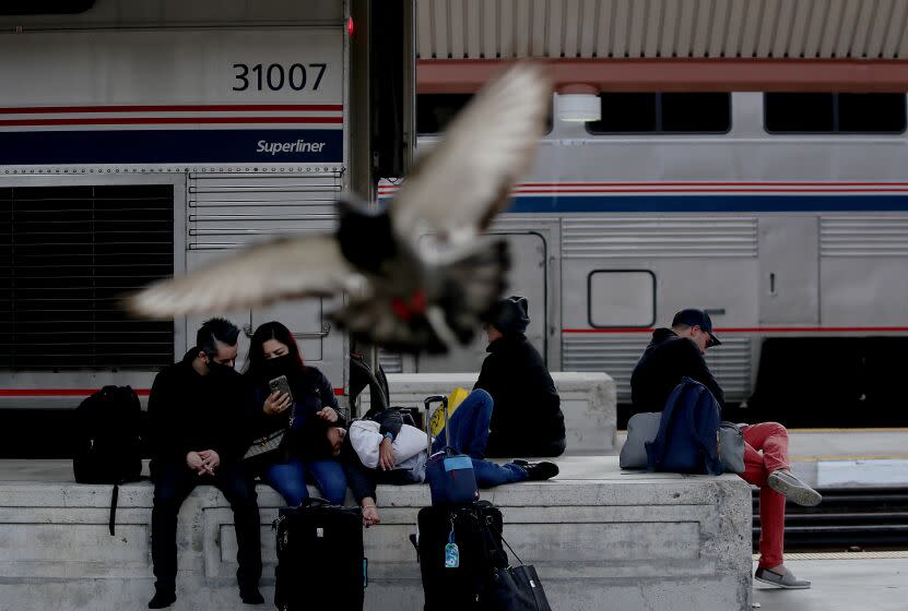 LOS ANGELES, CALIF. - APRIL 4, 2022. Passengers on a platform to board a train at Union Station in downtown Los Angeles on Monday, Apr. 4, 2022. Metrolink will reinstate service on 24 of the most in-demand lines and add two new trains as it gears up to serve commuters returning to work in downtown offices following the coronavirus pandemic. (Luis Sinco / Los Angeles Times)