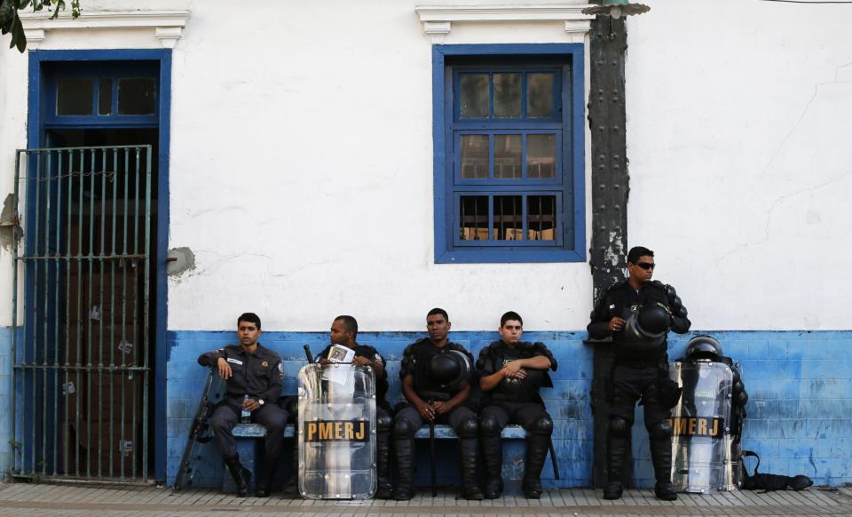 Riot police relax after a training session, with FBI agents, for troops providing security for the 2014 World Cup, in Rio de Janeiro