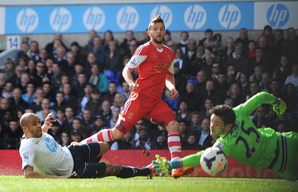 Tottenham Hotspur goalkeeper Hugo Lloris, right, and defender Younes Kaboul, left, fail to stop Southampton's Jay Rodriguez, from scoring his team's opening goal during the English Premier League match at White Hart Lane, London Sunday March 23, 2014. (AP {Photo/Adam Davy/PA) UNITED KINGDOM OUT