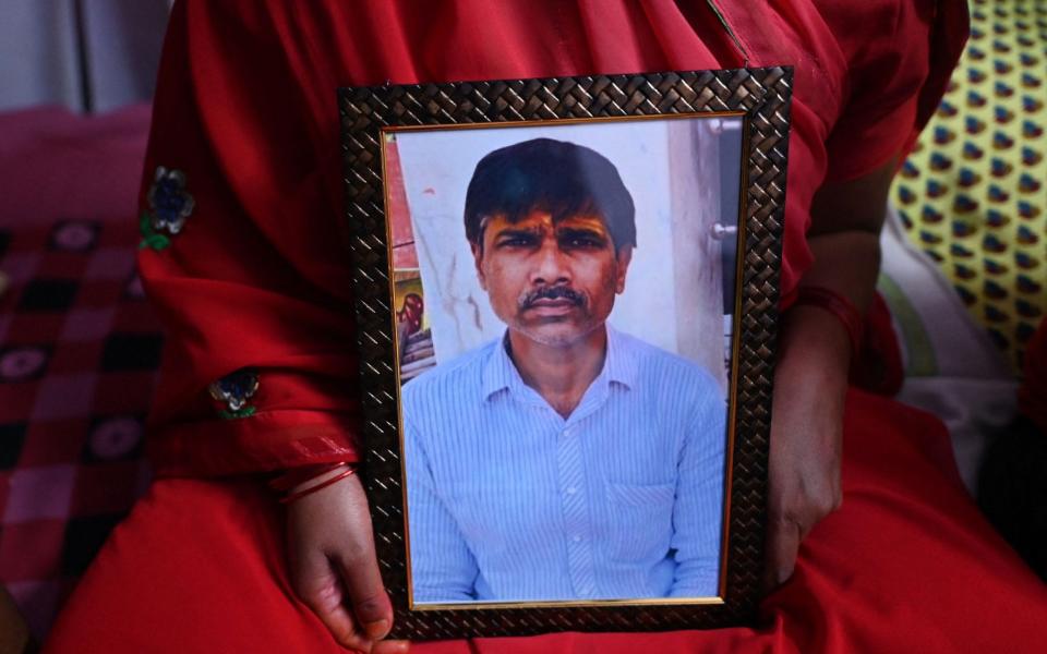 Jashoda Sahu Teli holds a picture of her slain husband Hindu tailor Kanhaiya Lal, who was allegedly killed by two Muslim men for supporting a former spokeswoman of the ruling Bharatiya Janata Party (BJP) party for her remarks about the Prophet Mohammed, at the family home in Udaipur - SAJJAD HUSSAIN/AFP via Getty Images