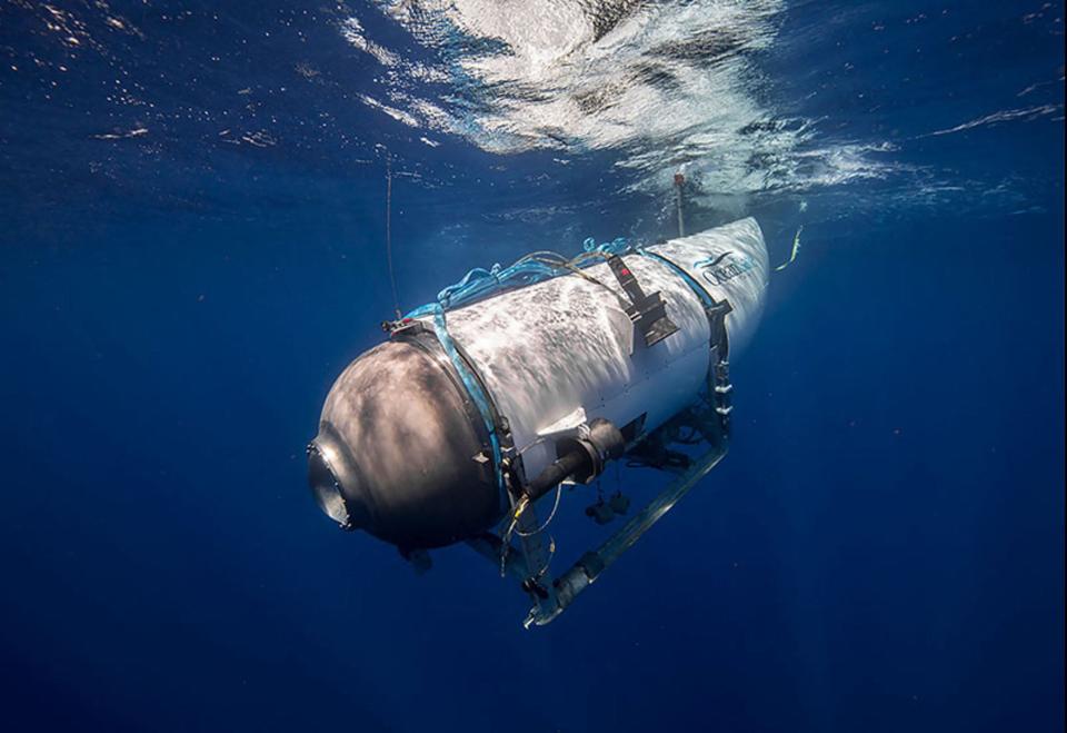 This undated image courtesy of OceanGate Expeditions, shows their Titan submersible beginning a descent. Rescue teams expanded their search underwater on June 20, 2023, as they raced against time to find a Titan deep-diving tourist submersible that went missing near the wreck of the Titanic with five people on board and limited oxygen.