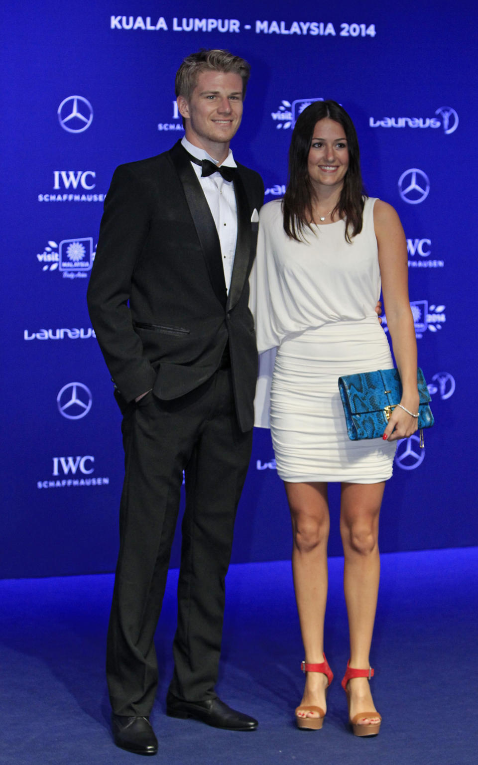 Germany's Formula One driver Nico Hulkenberg, left, and his girlfriend Laura pose for photos upon arriving at the Laureus World Sports Awards in Kuala Lumpur, Malaysia, Wednesday, March 26, 2014. (AP Photo/Lai Seng Sin)