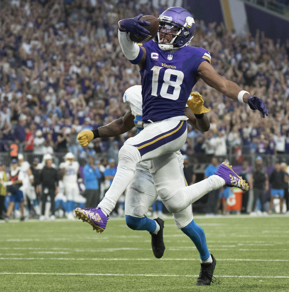 Minnesota Vikings wide receiver Justin Jefferson (18) scores his first touchdown of the year in the fourth quarter of an NFL football game against the Los Angeles Chargers, Sunday, Sept. 24, 2023, in Minneapolis. (Jerry Holt/Star Tribune via AP)