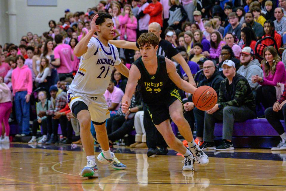 Rock Bridge's Brady Bowers (23) drives along the baseline past Hickman's Josiah Griffith (21) during the Bruins' 60-42 win over the Kewpies on Feb. 14, 2023, at Hickman High School.