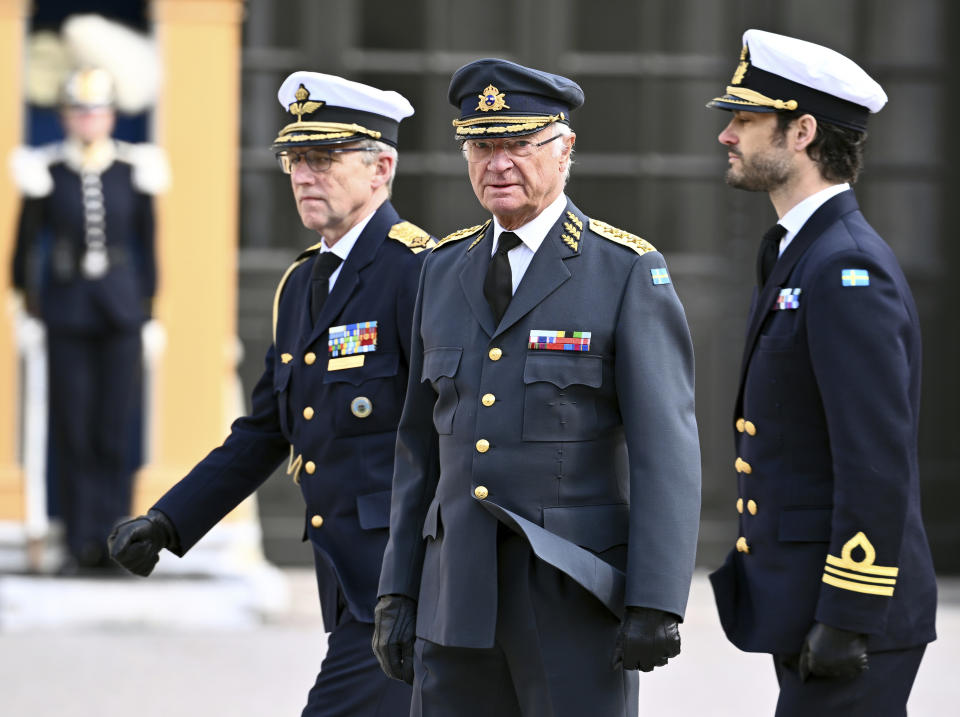 FILE - Sweden's King Carl XVI Gustaf, center, and Prince Carl Philip, right, at the celebration of King Carl Gustaf's birthday at Stockholm Palace in Stockholm, Sunday, April 30, 2023. Carl Gustaf made headlines in January this year when he appeared to suggest that the change in the succession rules had been unfair to Carl Philip. (Claudio Bresciani/TT News Agency via AP, File)