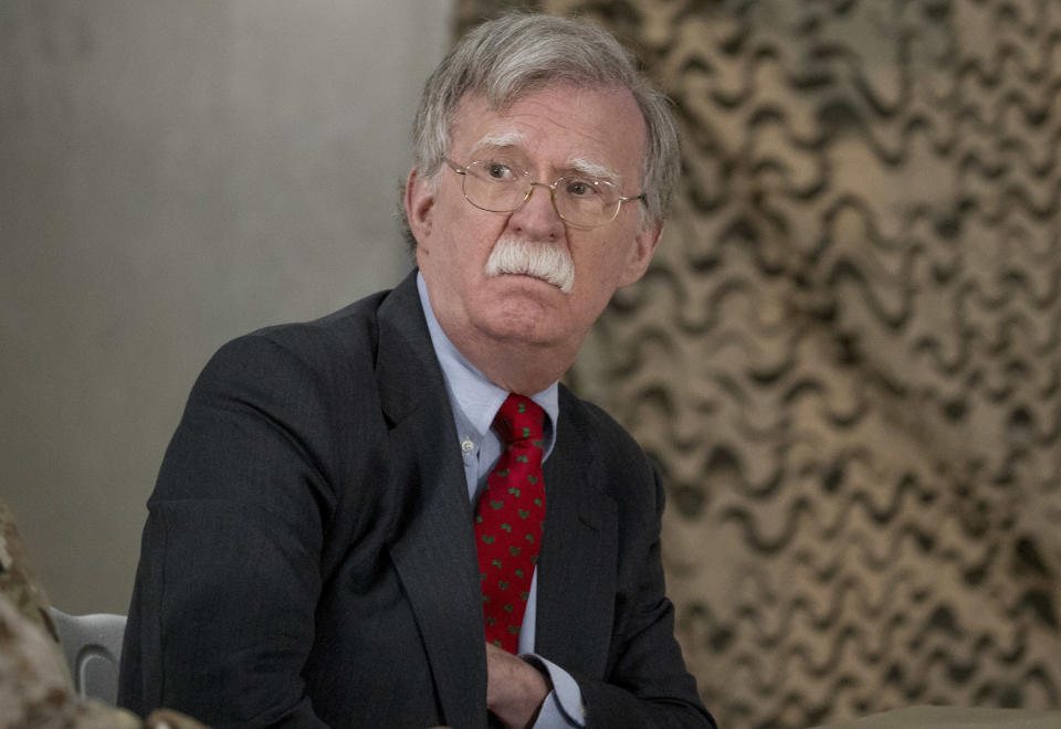 FILE - In this Dec. 26, 2018 file photo, National Security Adviser John Bolton attends a meeting with President Donald Trump and senior military leadership at Al Asad Air Base, Iraq. On Monday, Jan. 7, 2018, a Syrian Kurdish official said Syria's Kurds are awaiting clarifications from the U.S. over America's withdrawal plans following comments made by Bolton which appeared to contradict earlier comments by President Donald Trump. Bolton, on a visit to Israel Sunday, said U.S. troops will not leave northeastern Syria until IS militants are defeated and American-allied Kurdish fighters are protected. (AP Photo/Andrew Harnik, File)