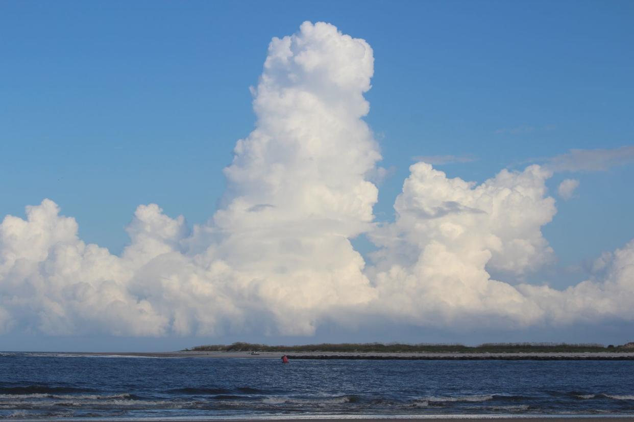 dramatic puffy white clouds over anastasia state park