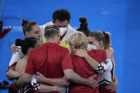 Team Germany huddles together after performing in the women's artistic gymnastic qualifications at the 2020 Summer Olympics, Sunday, July 25, 2021, in Tokyo. (AP Photo/Gregory Bull)