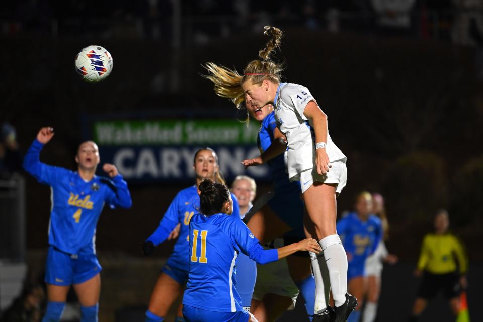 North Carolina's Avery Patterson (15) scores as UCLA's Lilly Reale (4), Madelyn Desiano (11) and Jayden Perry defend during Monday night's NCAA women's soccer championship.