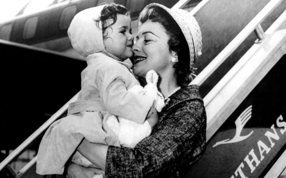 With her daughter Gisèle at Idlewild Airport in New York en route to their Paris home in 1958 - Rex Features/Rex Features