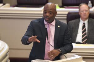 A man gesturing during a debate.