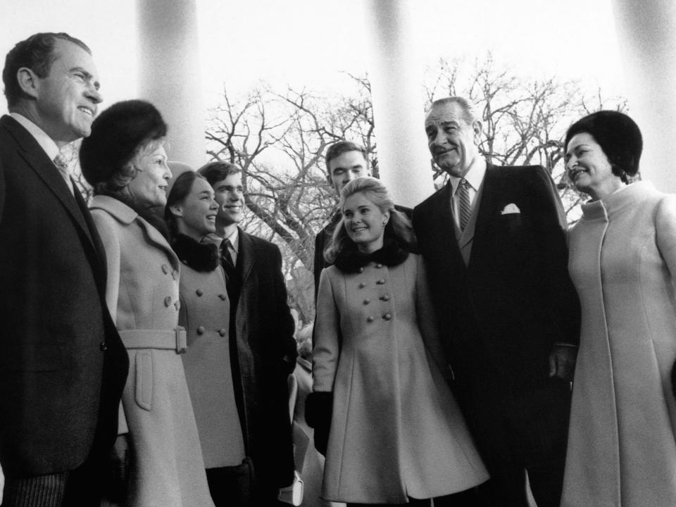 Richard Nixon, Pat Nixon, Patricia Nixon Cox, Edward F. Cox, Dwight David Eisenhower, II, Julie Nixon Eisenhower, Lyndon Baines and Lady Bird Johnson in a coat and fur hat.