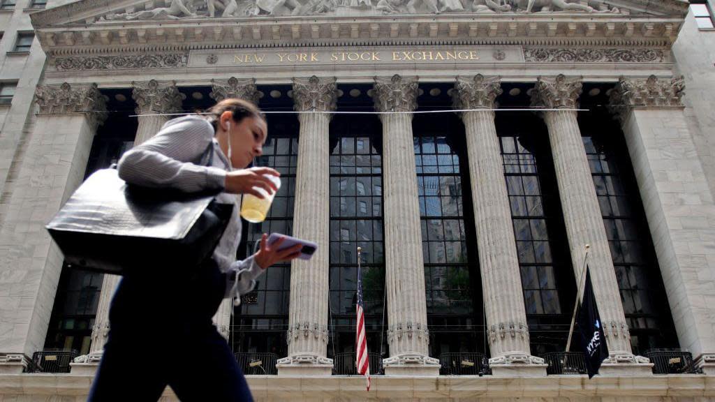  A woman walks near the New York Stock Exchange on July 18, 2023 in New York City.