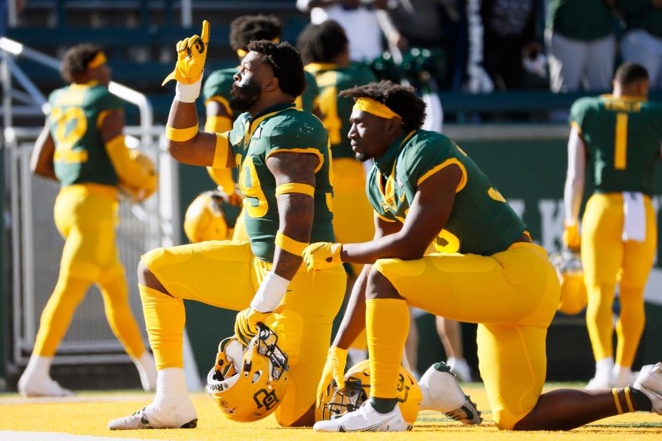 Baylor's William Bradley-King points skyward as he takes a knee in the end zone prior to the game against Oklahoma State.