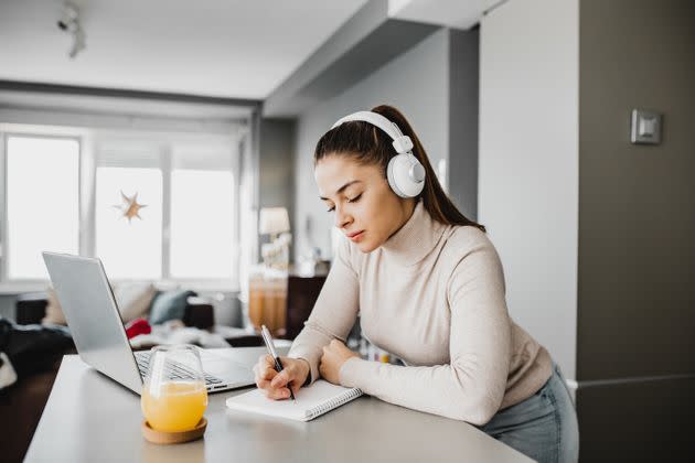 Playing music or a TV show in the background can feel calming, but if you're using it to drown out thoughts or feelings, you may need to try some other healthy coping techniques. (Photo: blackCAT via Getty Images)