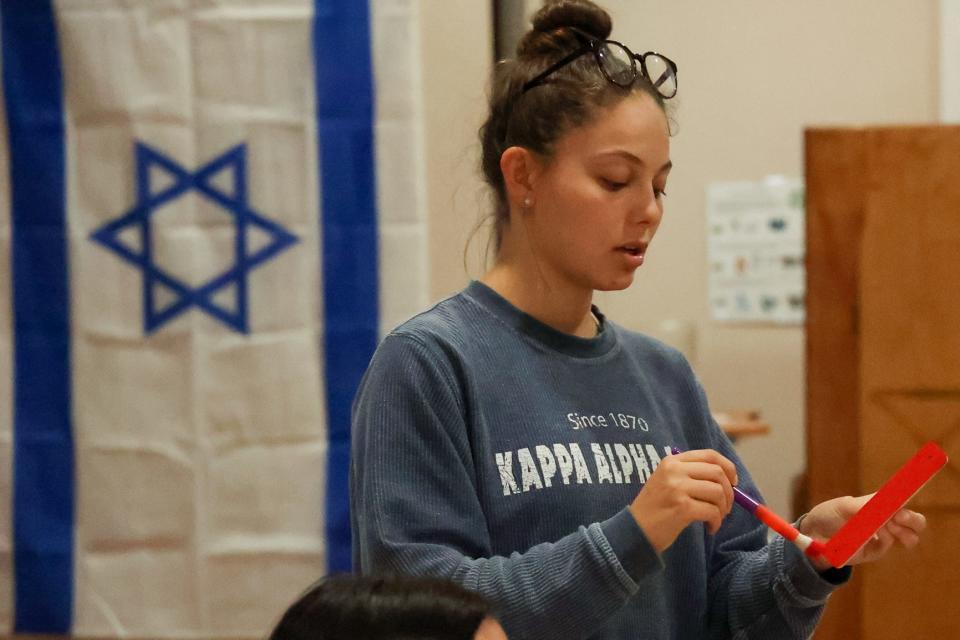 Kaylee Werner, a co-chair of the antisemitism taskforce at Indiana University Hillel. The task force painted and distributed dozens of red mezzuzahs, to replace Jewish prayer scrolls that had been vandalized. 
(Photo: Anya Heminger | Indiana Daily Student)