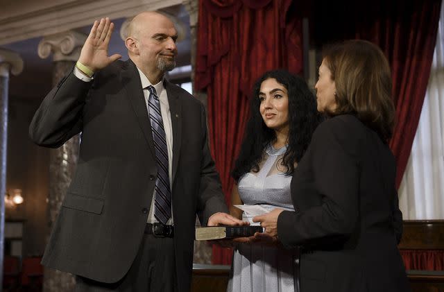 OLIVIER DOULIERY/AFP/Getty John Fetterman is sworn in by Vice President Kamala Harris as a U.S. senator, while wife Gisele holds the Bible