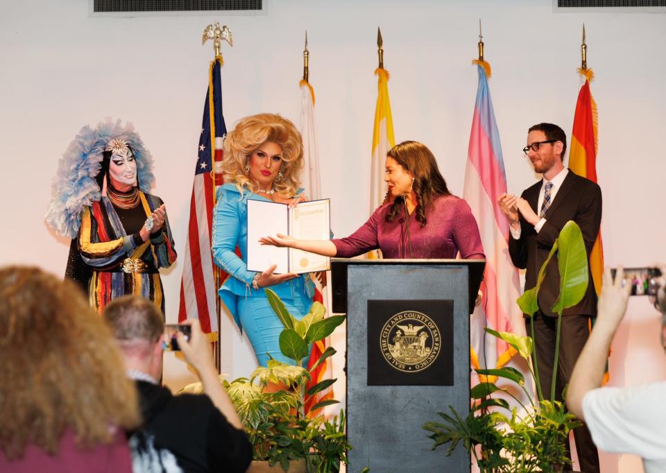 San Francisco Mayor London Breed presents D'Arcy Drollinger with a drag laureate certification.