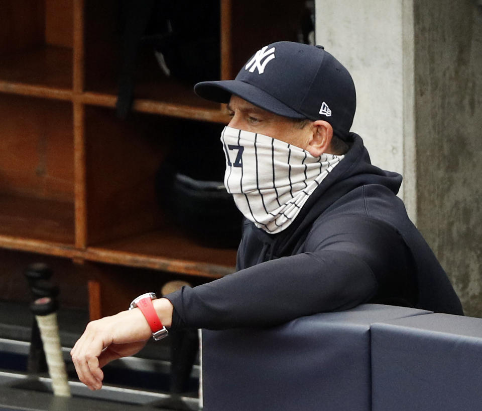 NEW YORK, NY - September 26:  Manager Aaron Boone #17 of the New York Yankees watches his team play while wearing his required face covering during an interleague MLB baseball game against the Miami Marlins on September 26, 2020 at Yankee Stadium in the Bronx borough of New York City. Yankees won 11-4. (Photo by Paul Bereswill/Getty Images)