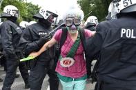 <p>A demonstrator dressed as a clown stands among policemen during a protest on July 7, 2017 in Hamburg. (Photo: Christof Stache/AFP/Getty Images) </p>