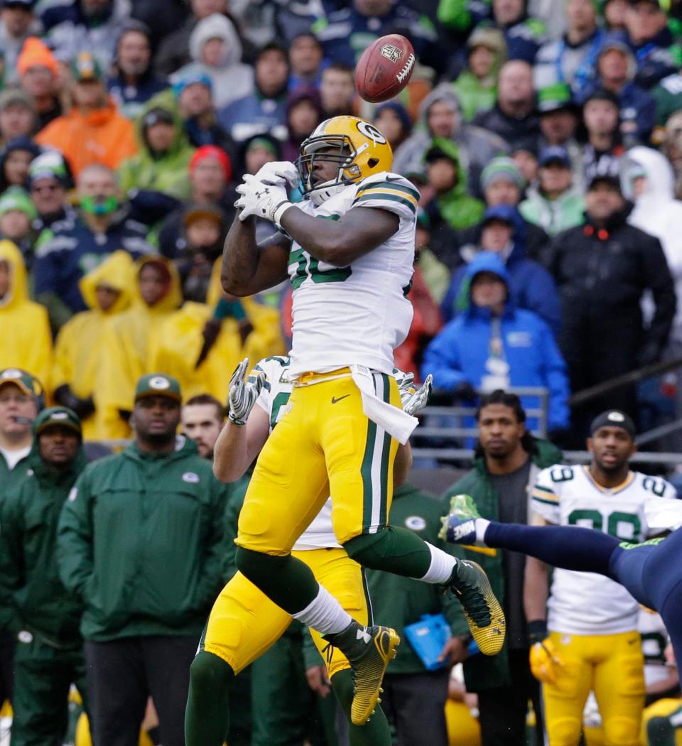 The play of the game might well have been an onside kick recovered by Seattle Seahawks wide receiver Chris Matthews (13).  Green Bay Packers tight end Brandon Bostick (86) made the initial touch on the ball but couldn't hang on while allowed a Seattle drive to continue with a  28-22 overtime win over the Green Bay Packers to win the NFC Championship football game at CenturyLink field in Seattle, Washington, Sunday, January 18, 2015.