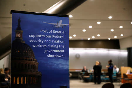 A Port of Seattle sign referencing the shutdown sits outside a resource fair for employees affected by the partial federal government shutdown at Seattle-Tacoma International Airport in Seattle, Washington, U.S., January 14, 2019. REUTERS/Lindsey Wasson