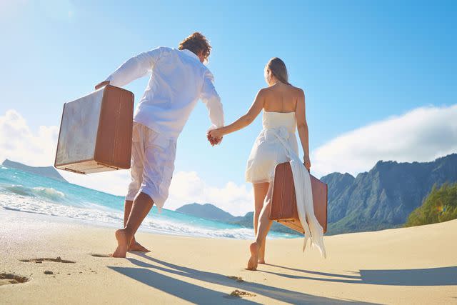 <p>Getty</p> A stock image of a couple on a beach