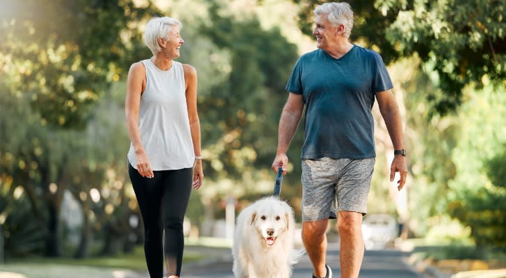 Couple in retirement walking their dog with $8 million in the bank