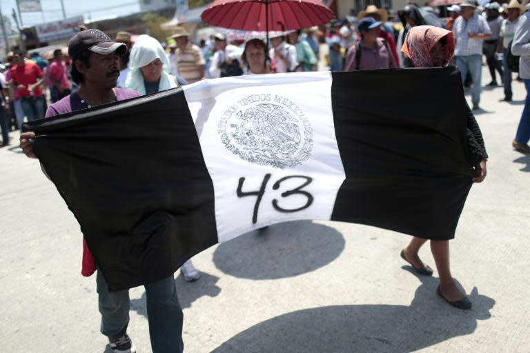 Parents and relatives of the 43 students from Ayotzinapa participate in a protest in Acapulco, Guerrero State, Mexico on March 24, 2015 demanding justice on their disappearance and on the death of teacher Claudio Castillo killed during a protest