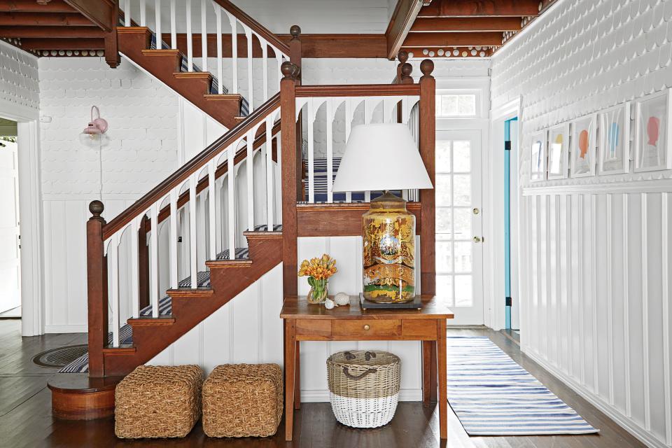 <p>Painting stair balusters white helped lighten the space and highlight a wave detail at the top of each spindle.</p>