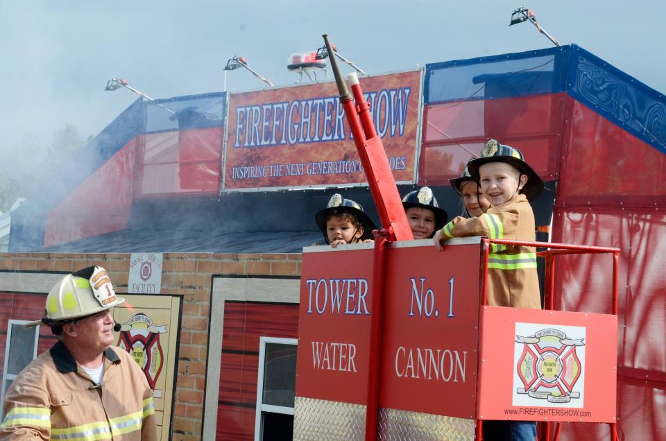 A group of junior firefighters takes part in the Firefighter Show at the Emmet-Charlevoix County Fair.