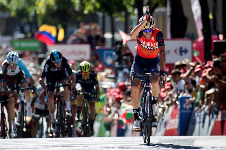 Vincenzo Nibali celebrates as he crosses the finish line to win the third stage of "La Vuelta" Tour of Spain on August 21, 2017