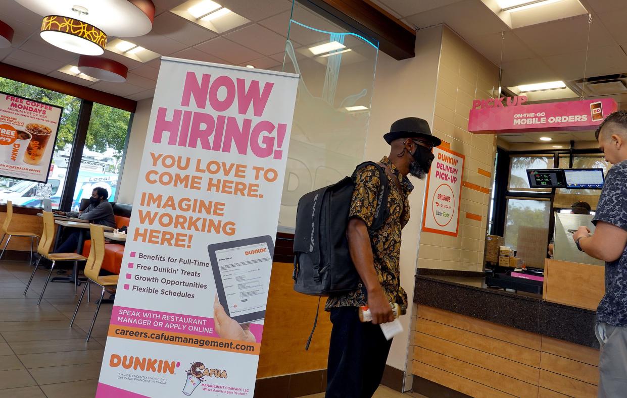 A Now Hiring sign at a Dunkin' restaurant on September 21, 2021 in Hallandale, Florida. 