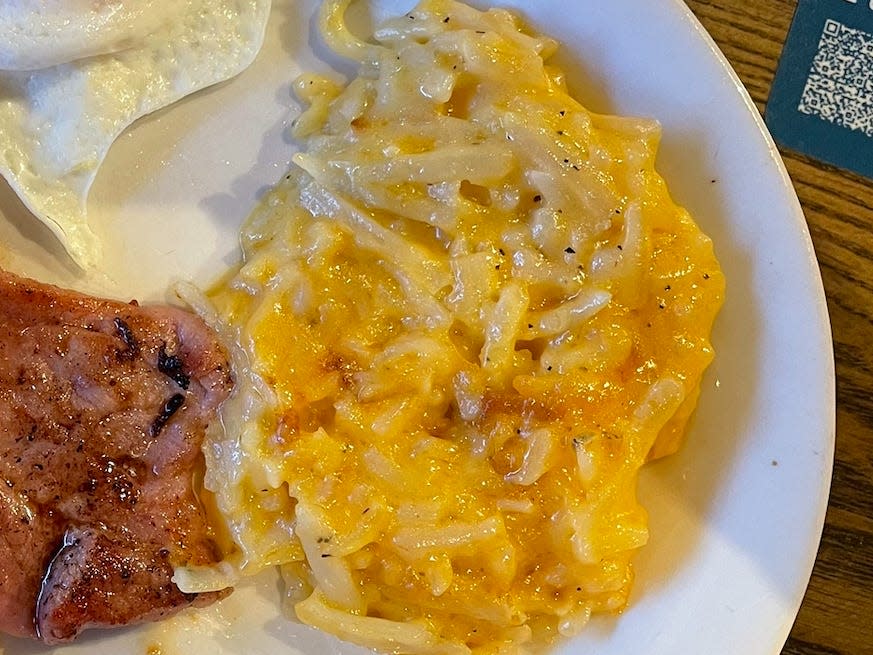 plate of ham, eggs, and hash brown casserole on a plate from cracker barrel