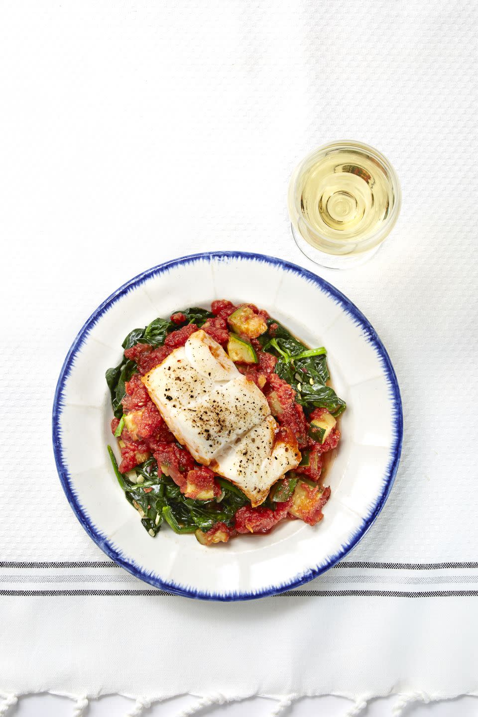 cod fish over sautéed greens and tomato sauce