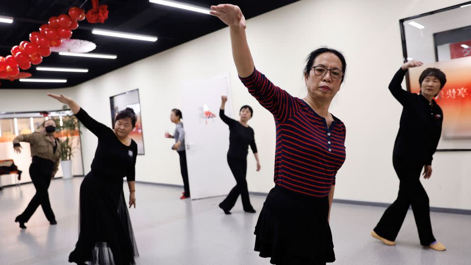 Retired kindergarten teacher Ma Qiuhua, 67, practices dancing with other elderly women at Mama Sunset, a learning center for middle-aged and elderly people in Beijing, China, January 15, 2024. - Tingshu Wang/Reuters