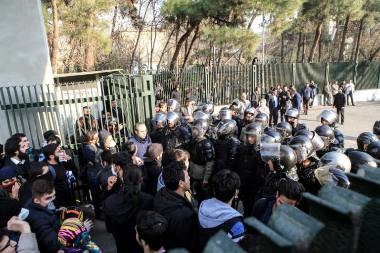 Iranian students scuffle with police at the University of Tehran during a demonstration on December 30, 2017