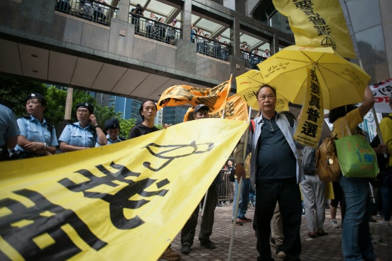 Protesters march in the Wan Chai district of Hong Kong on May 18, 2016 calling for universal suffrage and an end to arrests of activists in China as a top Beijing official visits the city