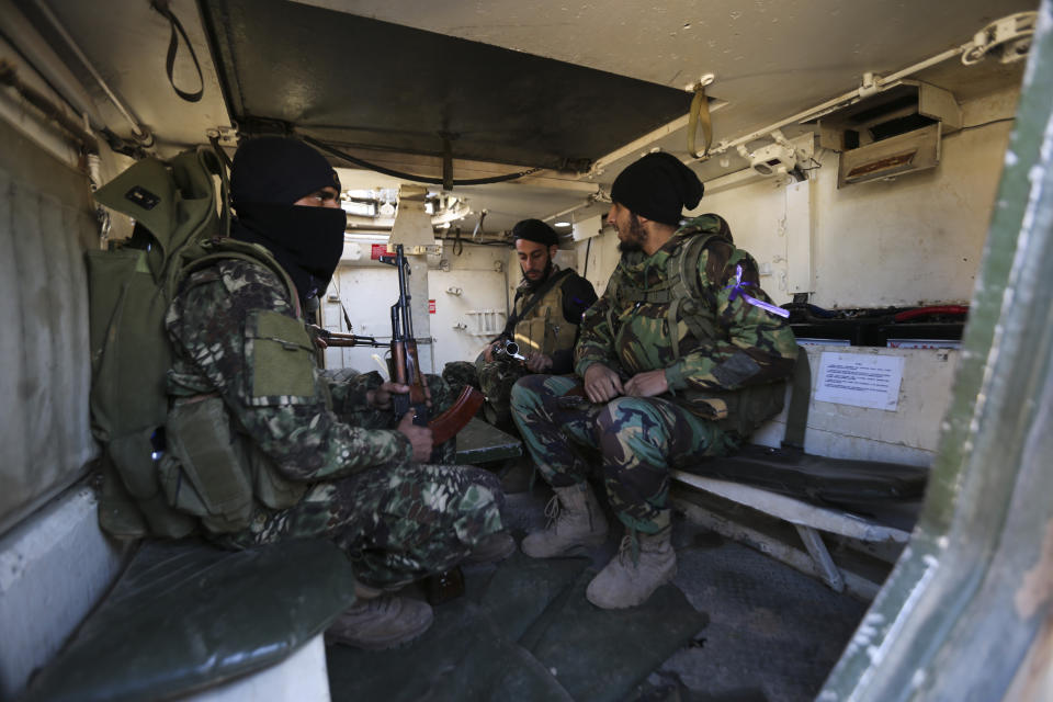 Turkish backed rebel fighters prepare for an attack near the village of Neirab in Idlib province, Syria, Thursday, Feb. 20, 2020. Two Turkish soldiers were killed Thursday by an airstrike in northwestern Syria, according to Turkey's Defense Ministry, following a large-scale attack by Ankara-backed opposition forces that targeted Syrian government troops. (AP Photo/Ghaith Alsayed)