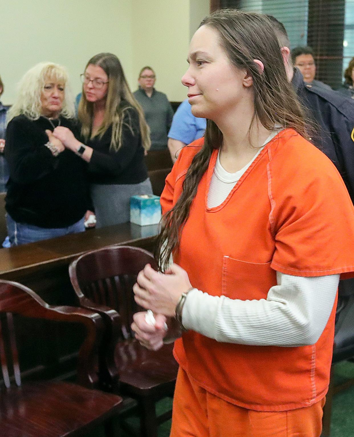 Kim Biggs, left, the mother of Ashley Biggs, is comforted by Summit County victim advocate Katie Thompson while Erica Stefanko is escorted away after being sentenced to life in prison with a possible parole after 30 years for her role in the 2012 murder of Ashley Biggs on Thursday in Akron.