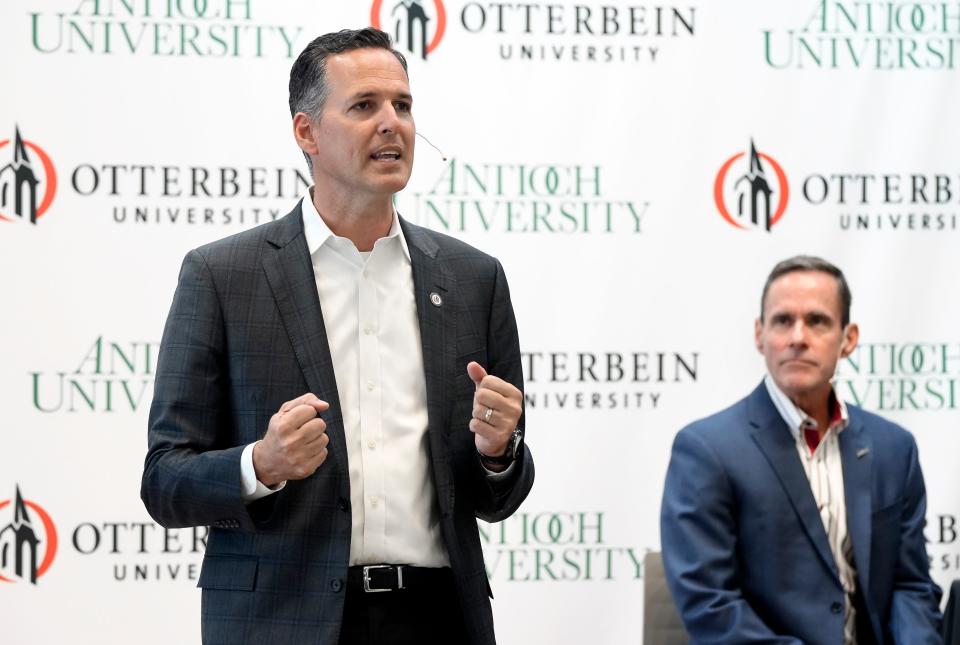 Otterbein University President John Comerford, left, speaks as Chancellor William R. Groves, of Antioch University, listens during a news conference announcing a partnership between the two schools.